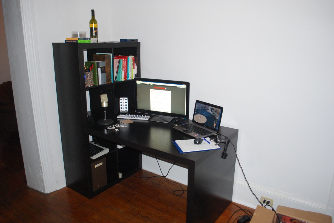 An ikea desk with a monitor and laptop on it