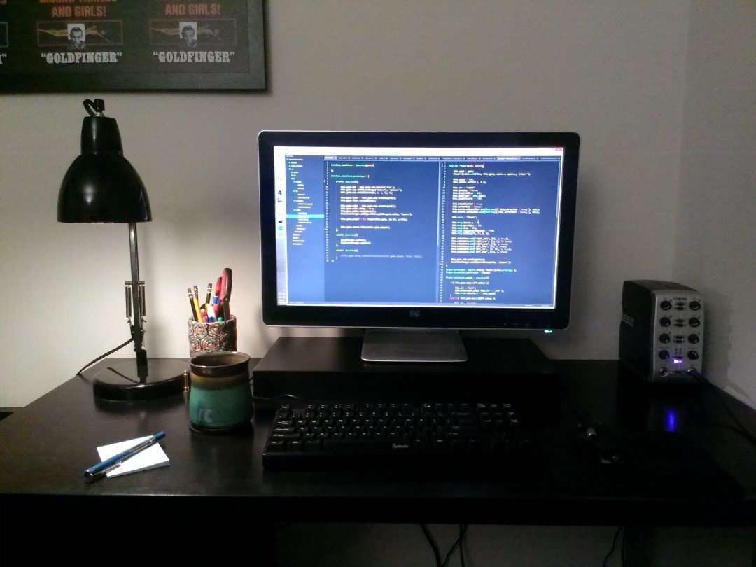 An ikea desk with a computer monitor and keyboard